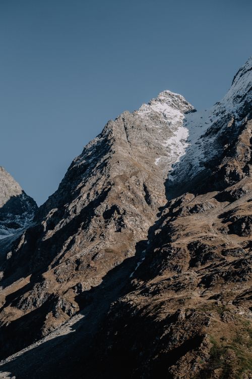 Free Stunning view of a rocky mountain peak against clear blue sky, showcasing rugged beauty. Stock Photo