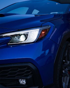 Detailed view of a blue sports car headlight showcasing sleek design in Canada.