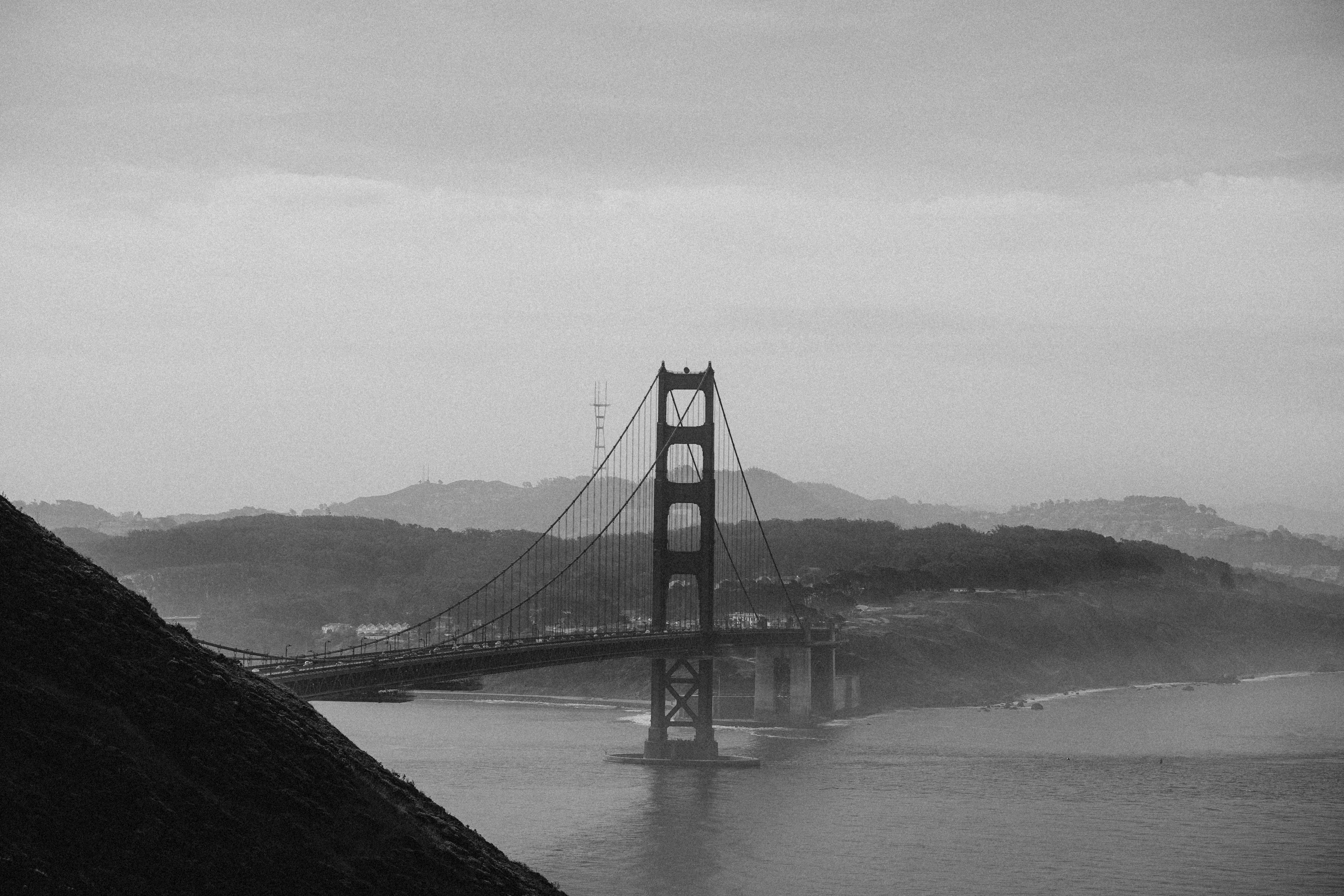 A serene black and white view of the Golden Gate Bridge on a misty day in San Francisco.