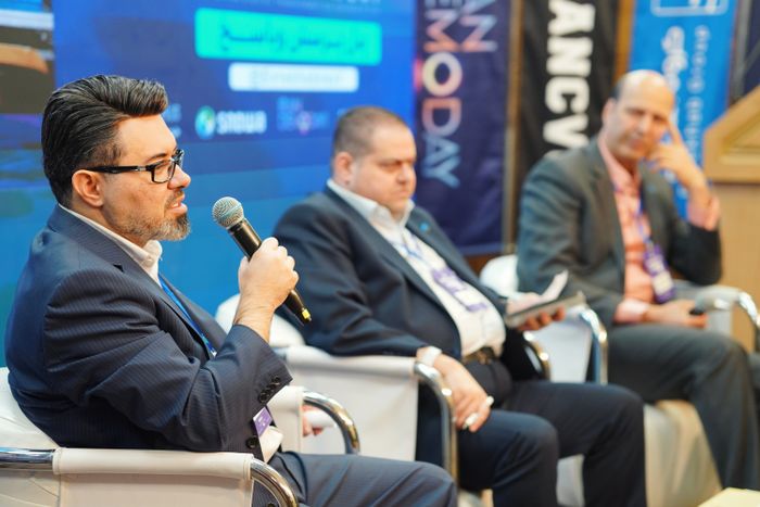 Speakers taking part in a panel discussion at a professional conference