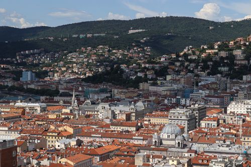 Free Explore the charming architecture of Trieste from above, showcasing its iconic red rooftops and surrounding hills. Stock Photo