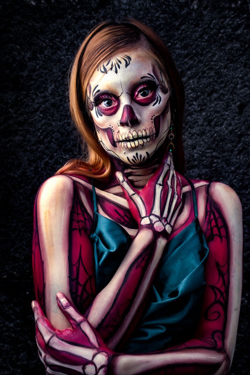 Free Artistic depiction of Catrina costume with skeleton face paint against a dark background, highlighting cultural themes. Stock Photo