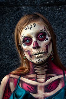 A woman adorned with intricate Catrina face paint and skeleton body art, showcasing cultural artistry.