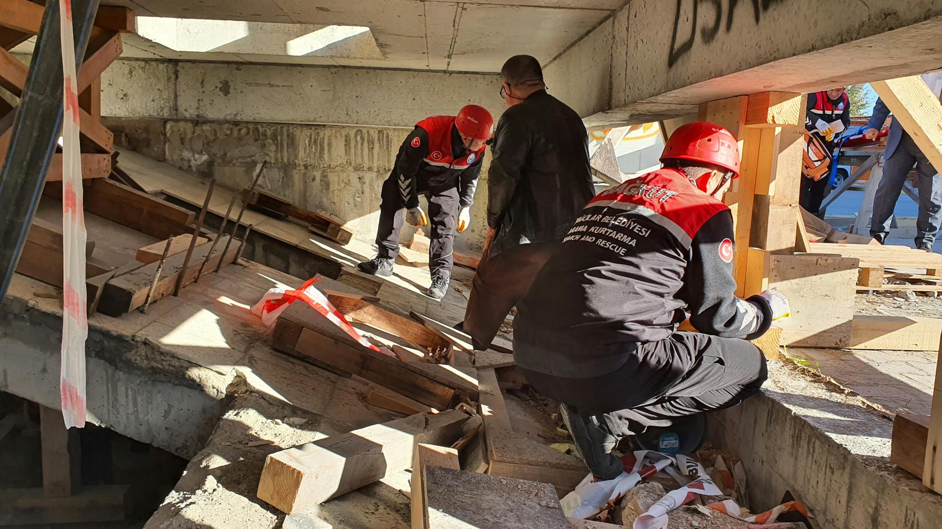 Rescue workers in Istanbul inspecting a damaged structure for safety and recovery efforts.