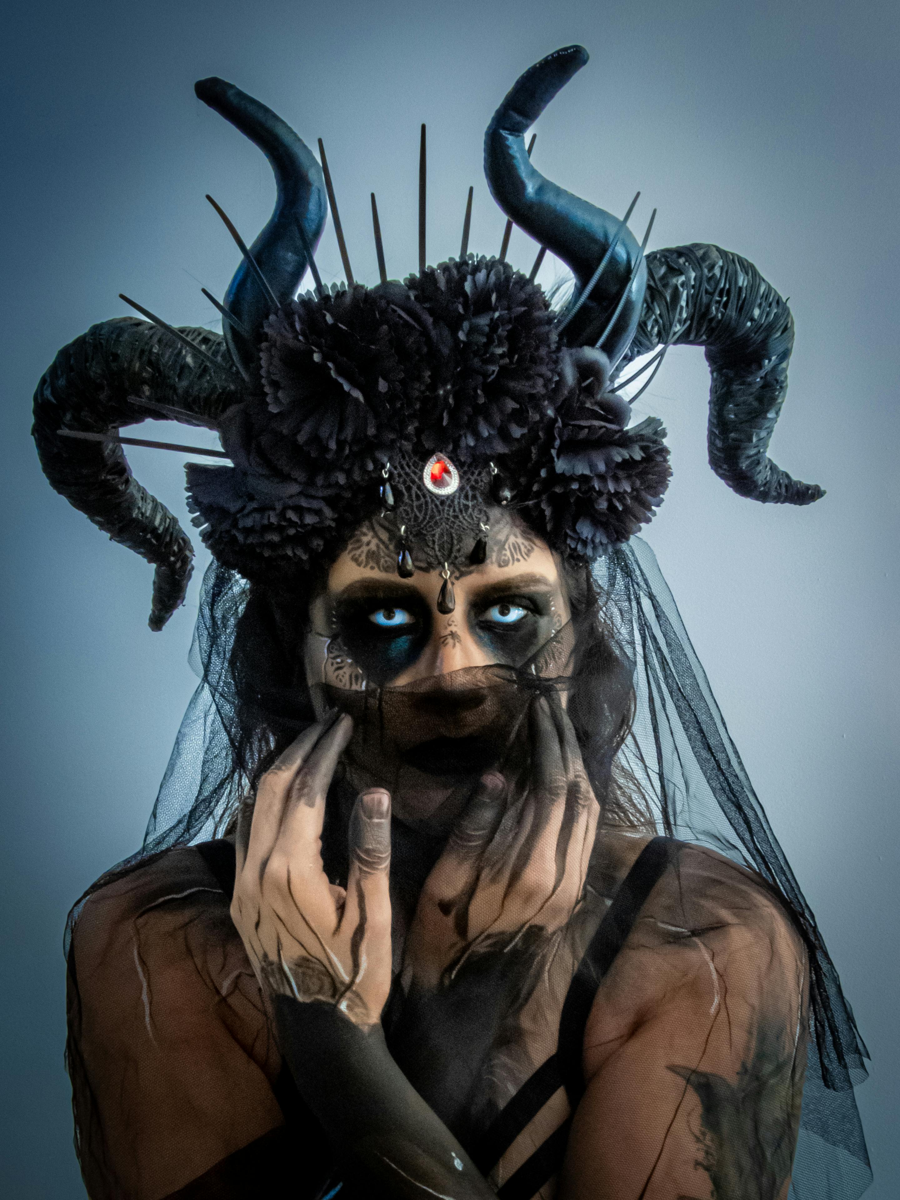 grátis Fantasia cativante de Halloween com tema de demônio, com enfeite de cabeça e maquiagem elaborados. Foto profissional