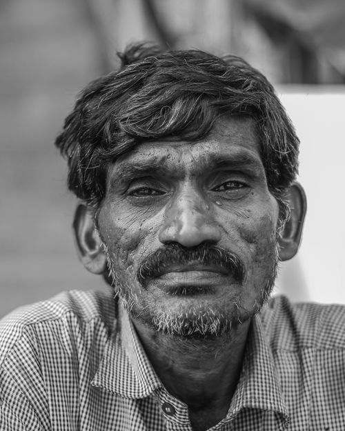Free Close-up black and white portrait of an elderly man with a deep expression and textured features. Stock Photo