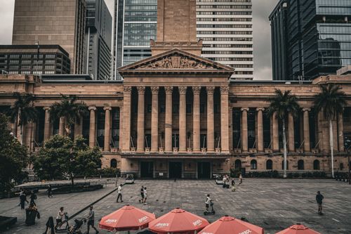 Free A view of Brisbane City Hall with urban surroundings and pedestrians in the plaza. Stock Photo