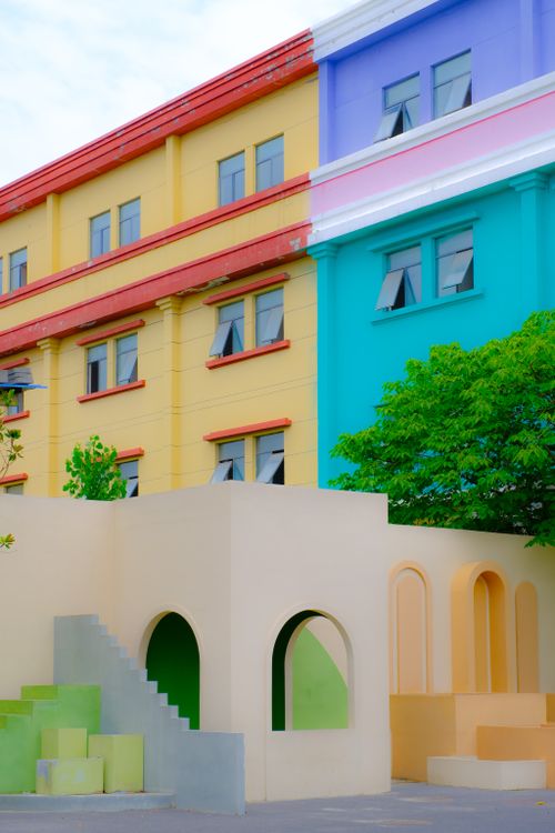 Free Vibrant multicolored building facade featuring modern architectural design. Ideal for urban and architectural themes. Stock Photo