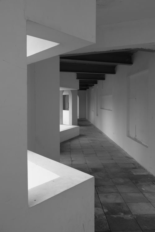 Free Architectural corridor with unique angles in black and white. Stock Photo