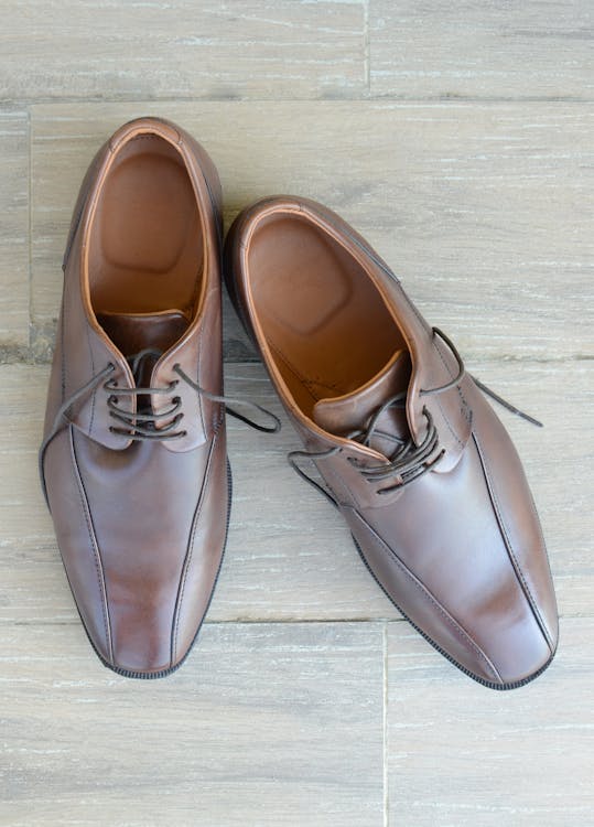 Pair of Brown Leather Dress Shoes Placed on Gray Surface