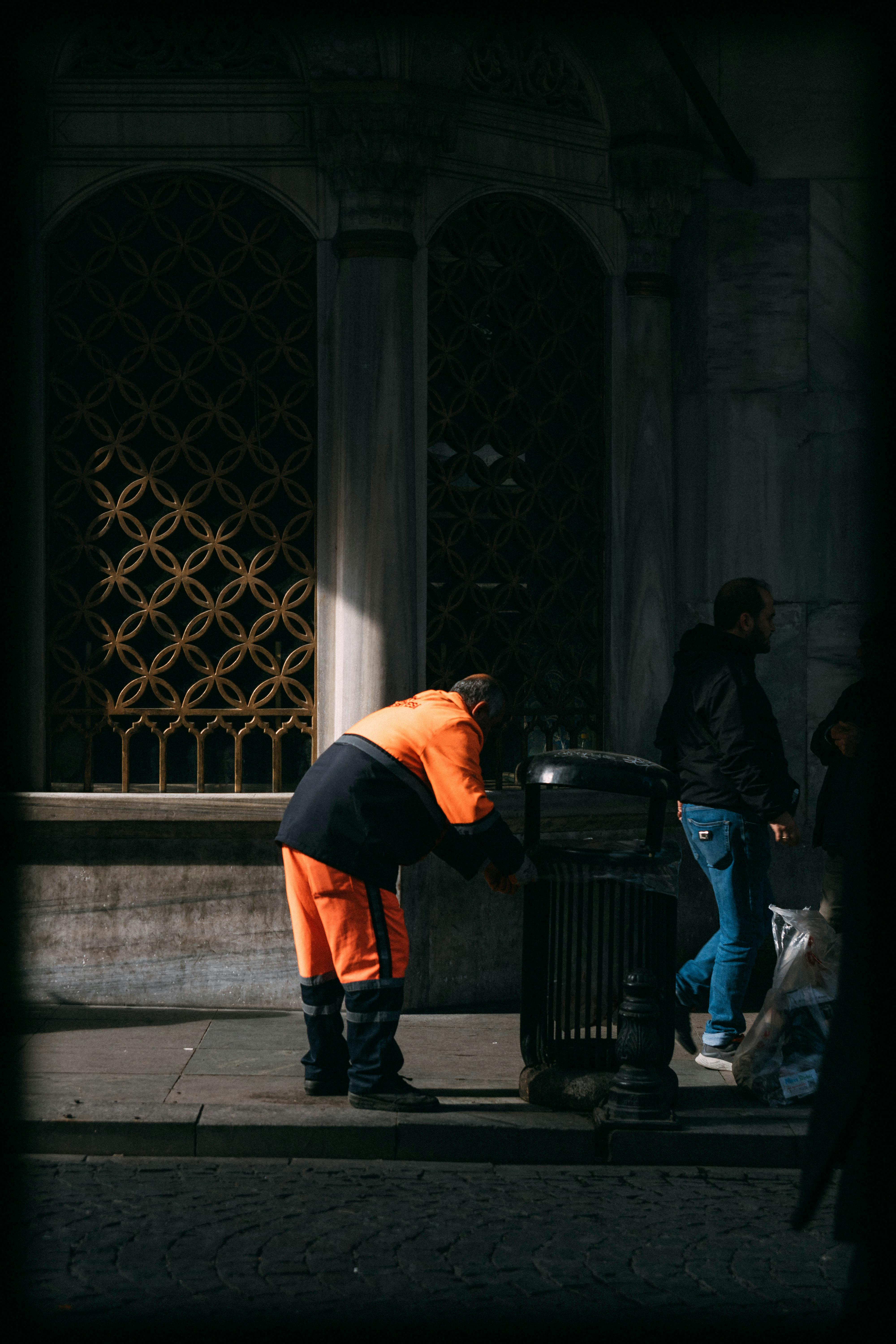 street cleaner in vibrant orange working daytime