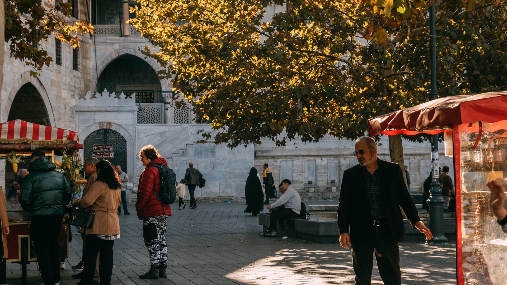 Legit Modafinil Vendor: Your Guide to Smart Drug Sources People enjoying a vibrant autumn day market by a historic building.