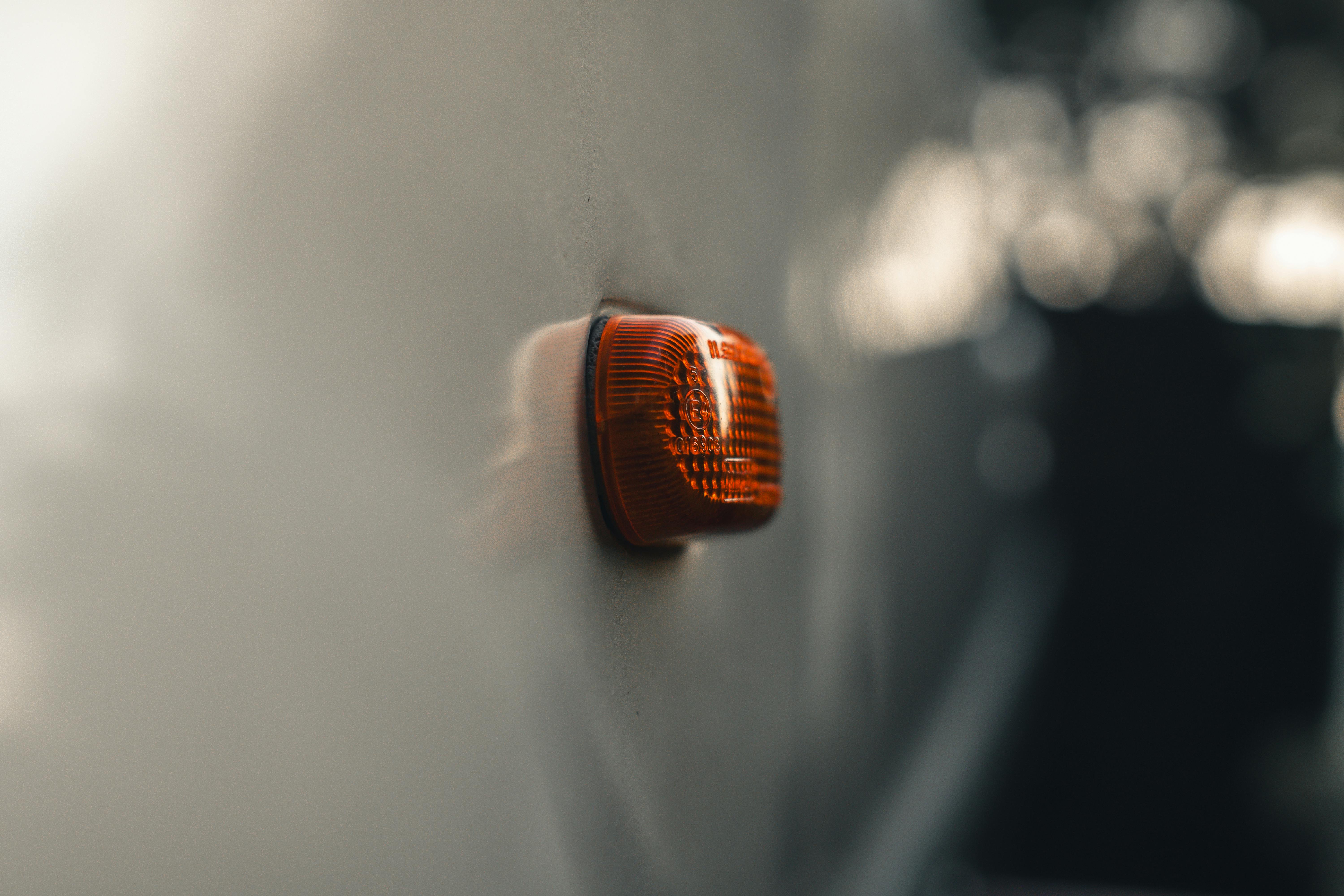 Gratis Ripresa macro dettagliata di una luce di posizione laterale arancione di un veicolo su uno sfondo sfocato. Foto a disposizione