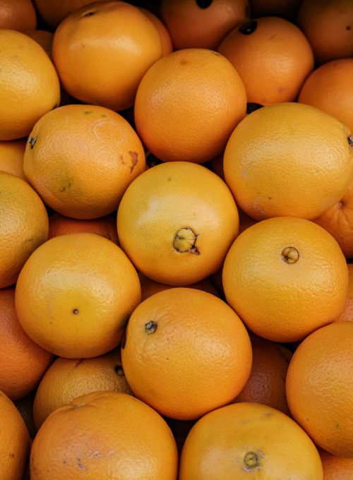 Free A top-down view of a pile of fresh oranges with vivid color and texture. Stock Photo