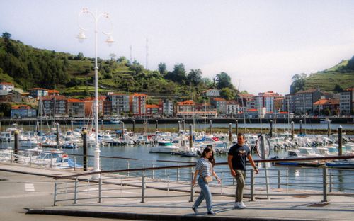 Free Sunny day at a marina in Asturias, Spain, with scenic harbor and hills. Stock Photo