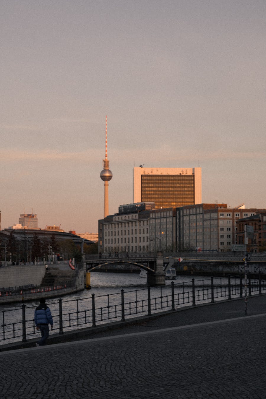 Scenic view of Berlin's skyline featuring the TV Tower during sunset with a river in the foreground
