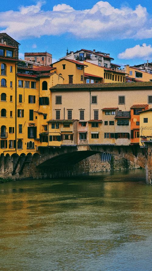 Free Colorful buildings on the historic Ponte Vecchio over the Arno River in Florence, Italy. Stock Photo