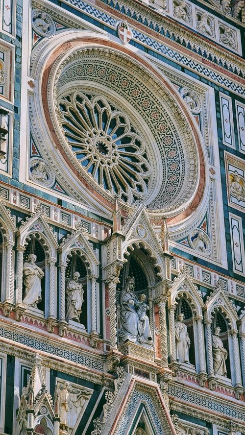 Free Detailed view of the gothic facade of Florence Cathedral showcasing intricate sculptures and rose window. Stock Photo