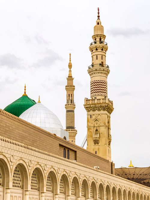 Free Iconic minarets of the Prophet's Mosque in Medina with detailed architecture and domes. Stock Photo