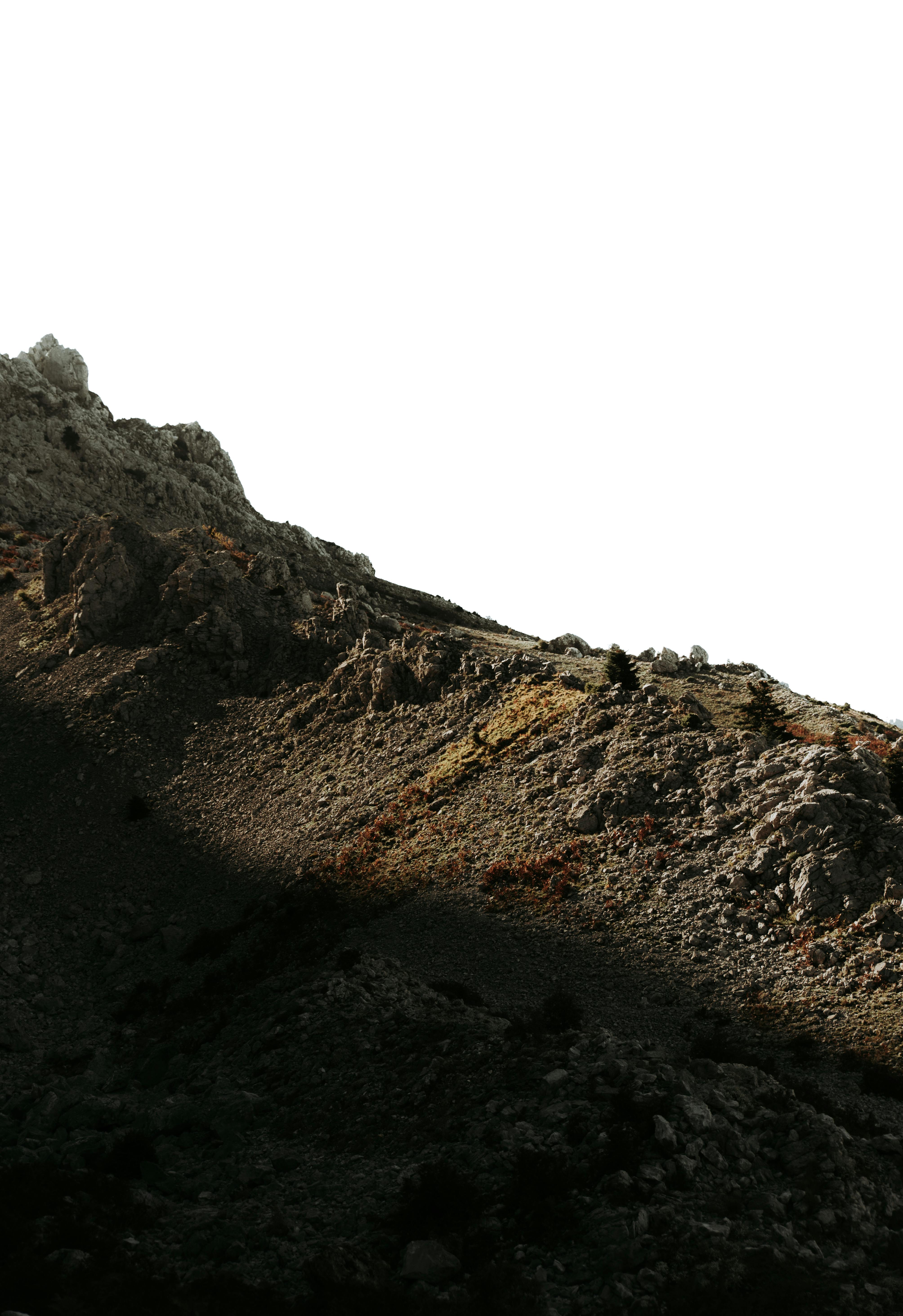 A striking contrast between sunlight and shadow on a rugged mountainside.