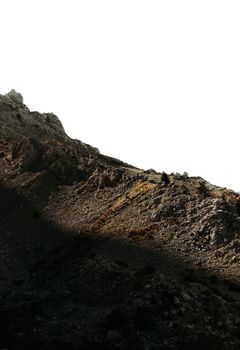 A striking contrast between sunlight and shadow on a rugged mountainside.