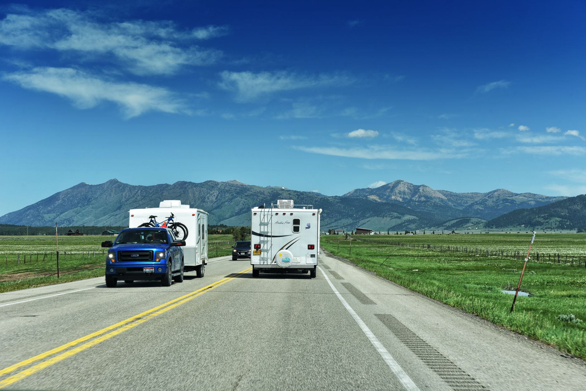 RVs traveling through a mountain landscape near Yellowstone