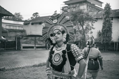 Free Black and white image showcasing a Kathakali dancer in traditional attire outdoors. Stock Photo