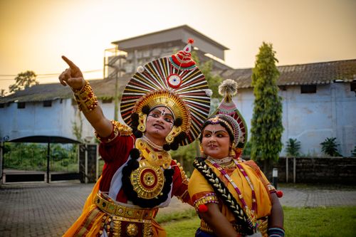 Free Colorful depiction of Indian classical dance performers in traditional attire outdoors at sunset. Stock Photo