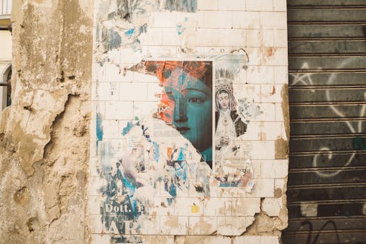 Faded religious posters on a rustic wall in Palermo, capturing urban decay and historical echoes.