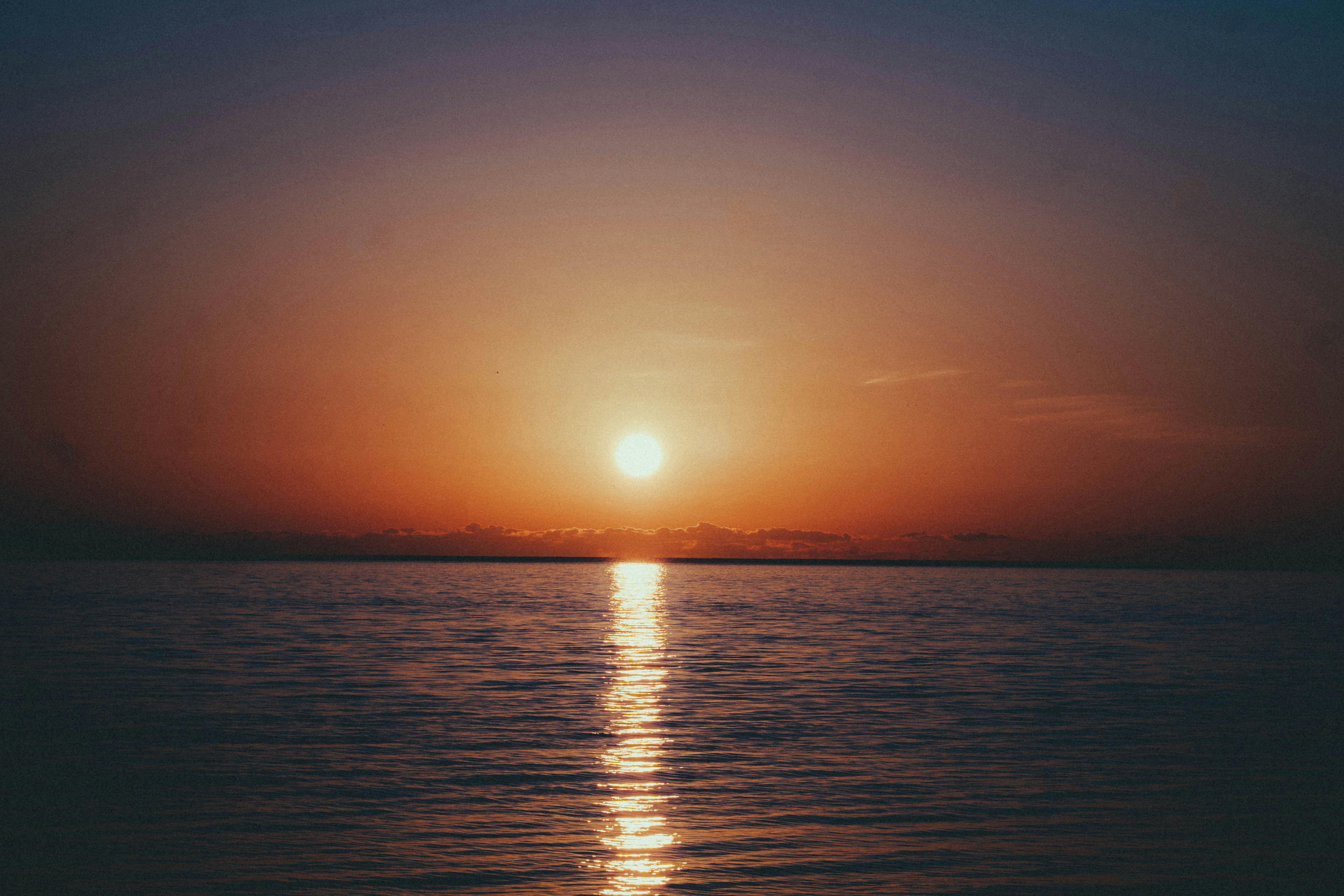Peaceful sunset over the calm sea in Batumi, Georgia, with vibrant hues and tranquil waters.