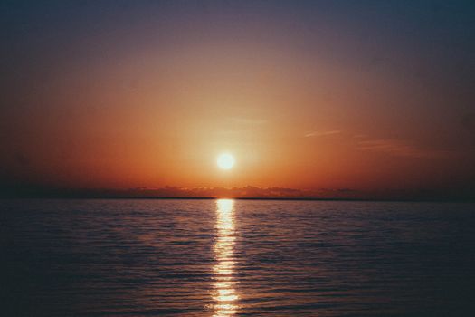 Peaceful sunset over the calm sea in Batumi, Georgia, with vibrant hues and tranquil waters.