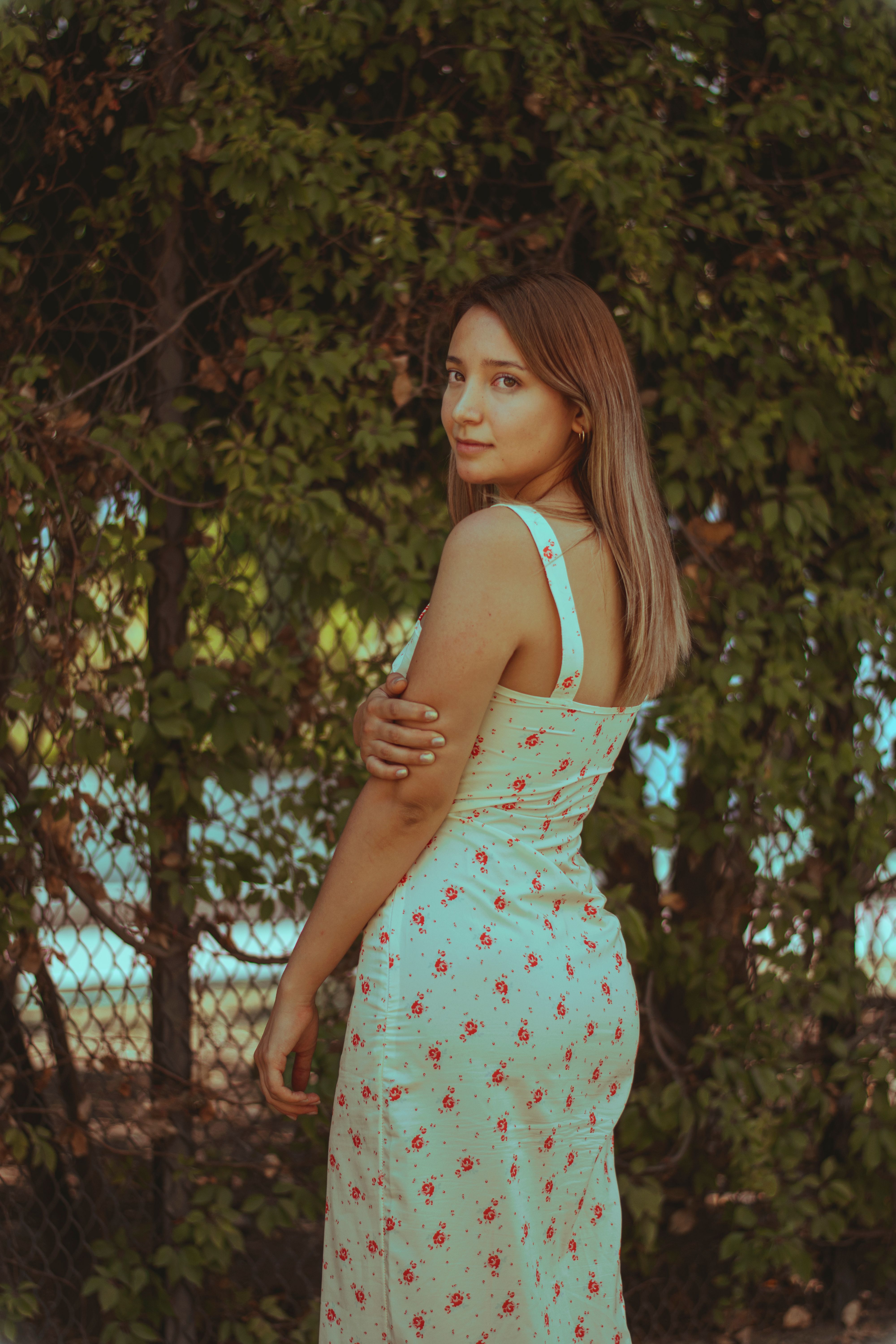 Young Woman in Floral Dress Outdoors · Free Stock Photo