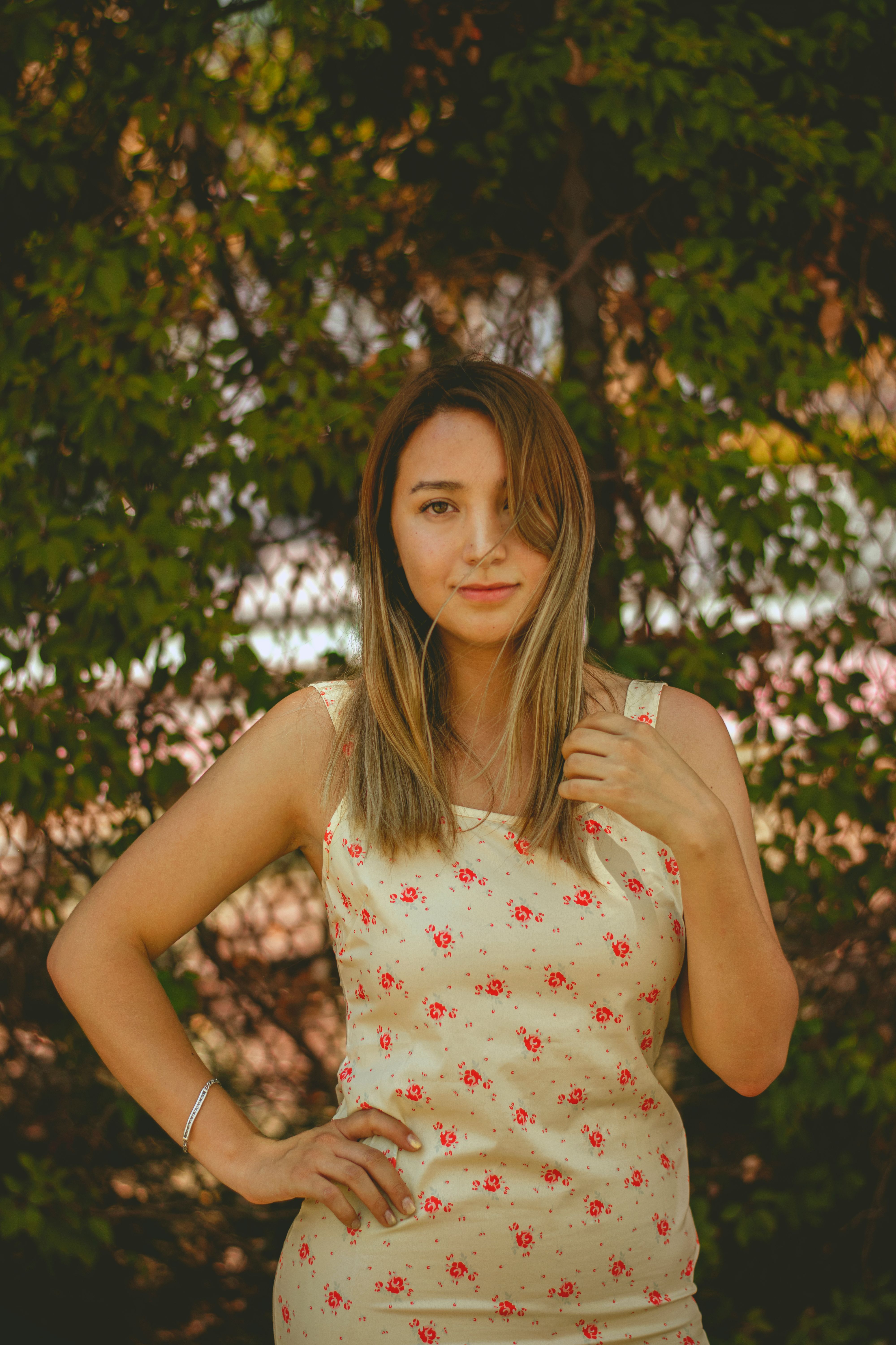 Portrait of a Woman in Floral Dress Outdoors · Free Stock Photo