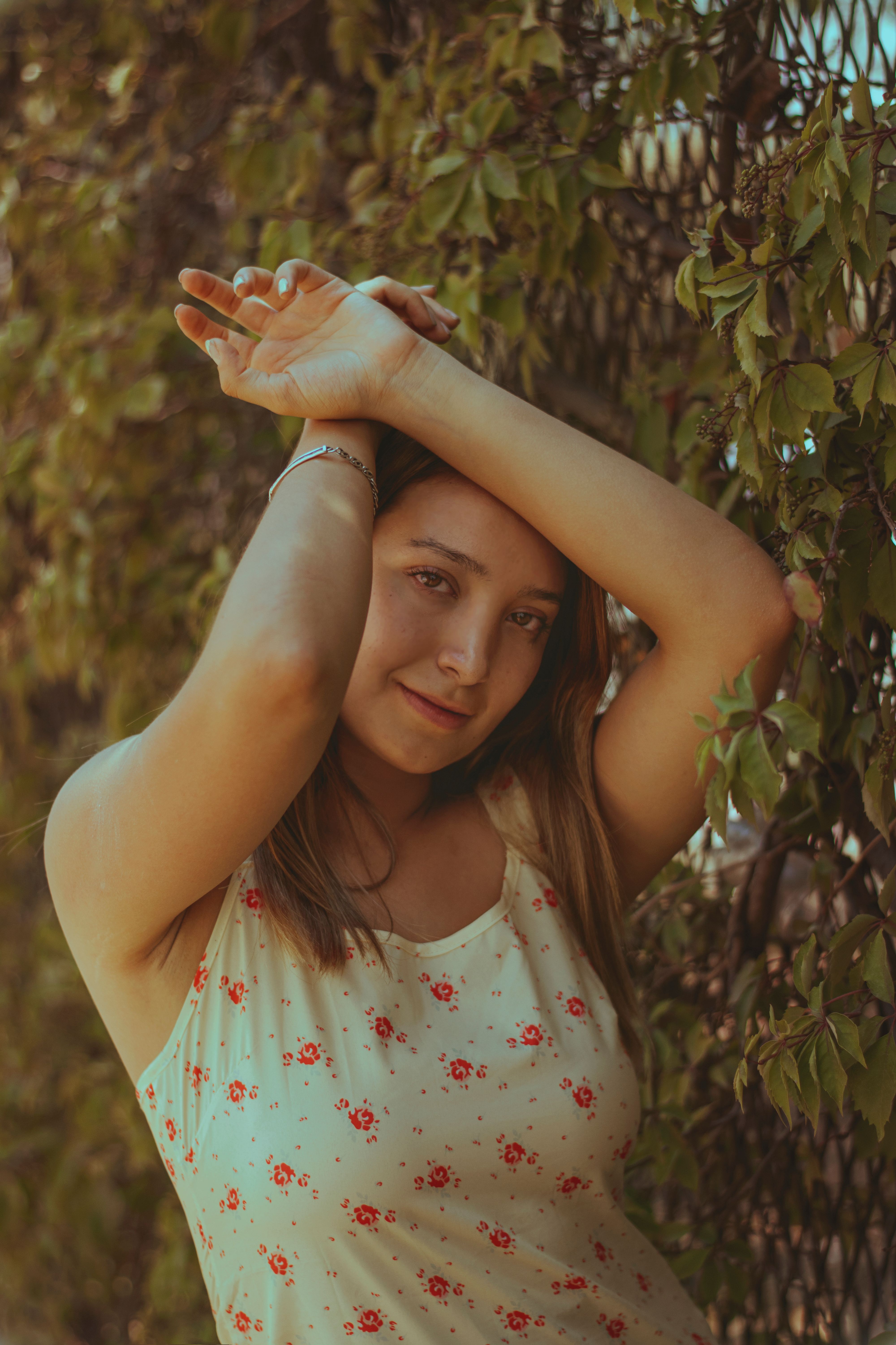 Young Woman Posing Outdoors by Leafs · Free Stock Photo