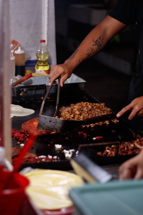 Free A chef preparing authentic Mexican tacos at a street food stand in Mexico City. Stock Photo