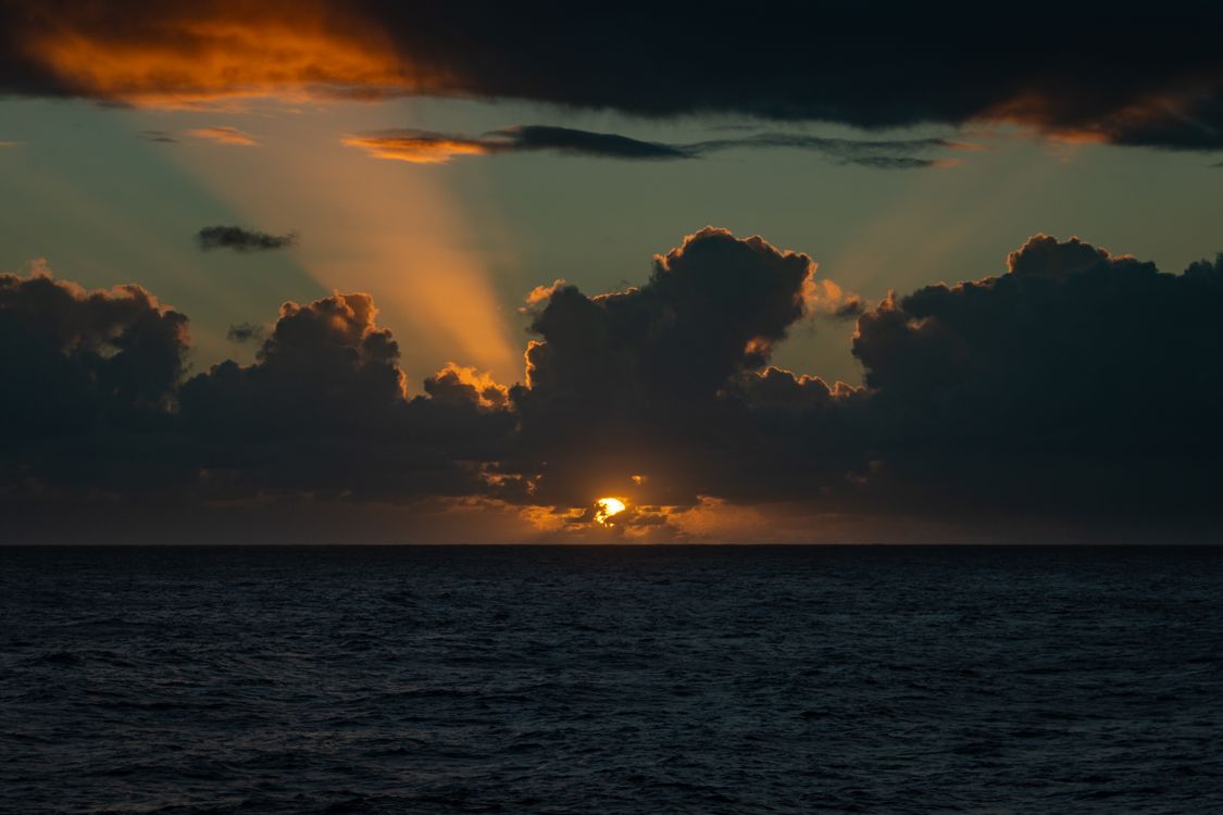 Dramatic Sunset Over the Ocean Horizon · Free Stock Photo