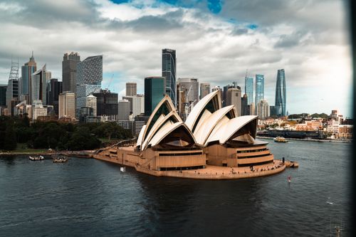 Free Stunning aerial view of the Sydney Opera House with the city skyline in the background. Stock Photo