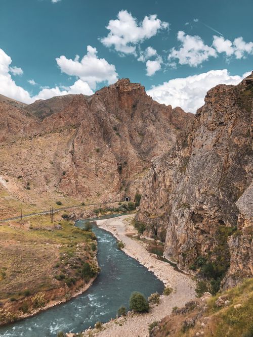 Free Stunning view of a river winding through a rocky canyon under a blue sky. Stock Photo
