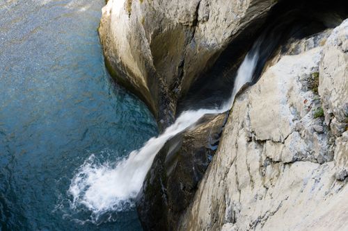 Free Majestic waterfall cascading through rocky terrain in Lauterbrunnen, Switzerland. Stock Photo