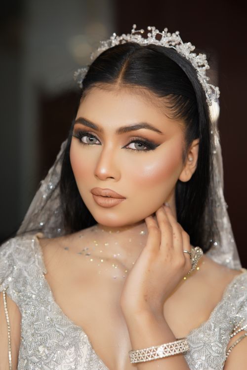 Free Elegant bride with intricate makeup, wearing a beautiful tiara and gown, perfect for weddings. Stock Photo