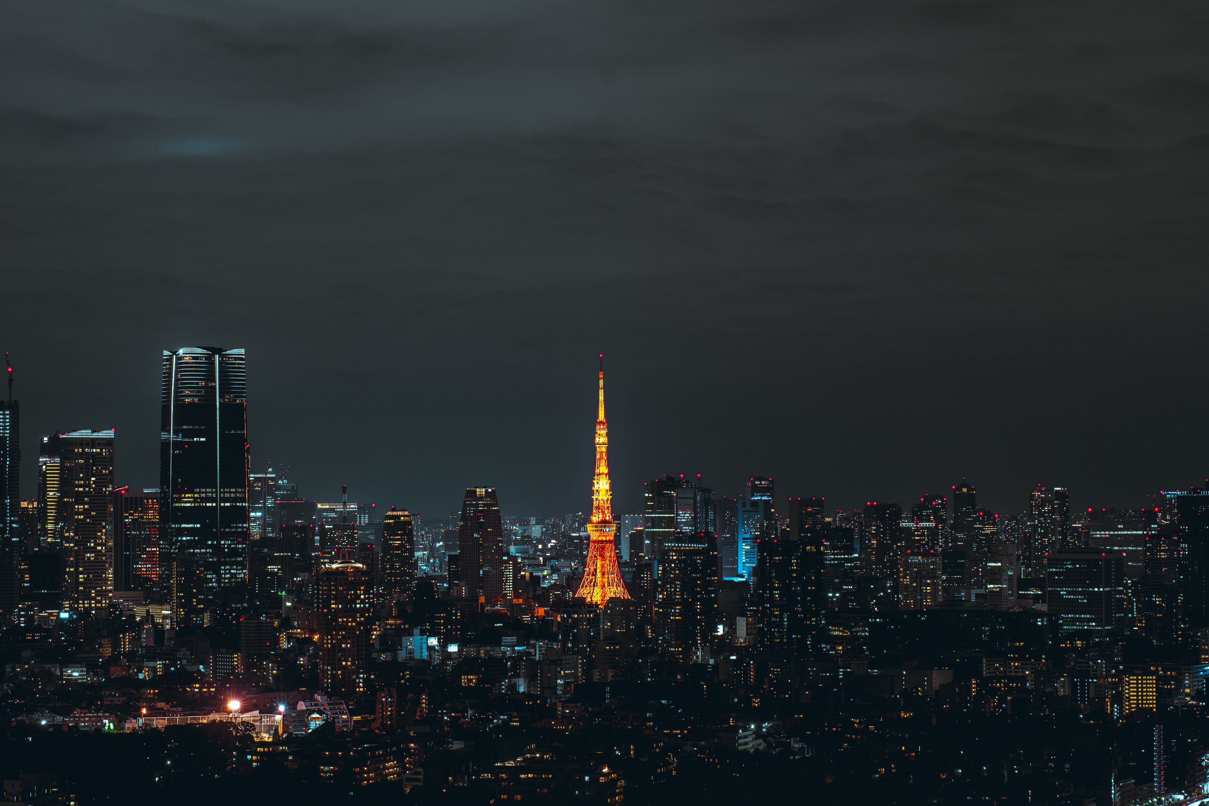 Stunning night view of Tokyo skyline featuring the illuminated Tokyo Tower.