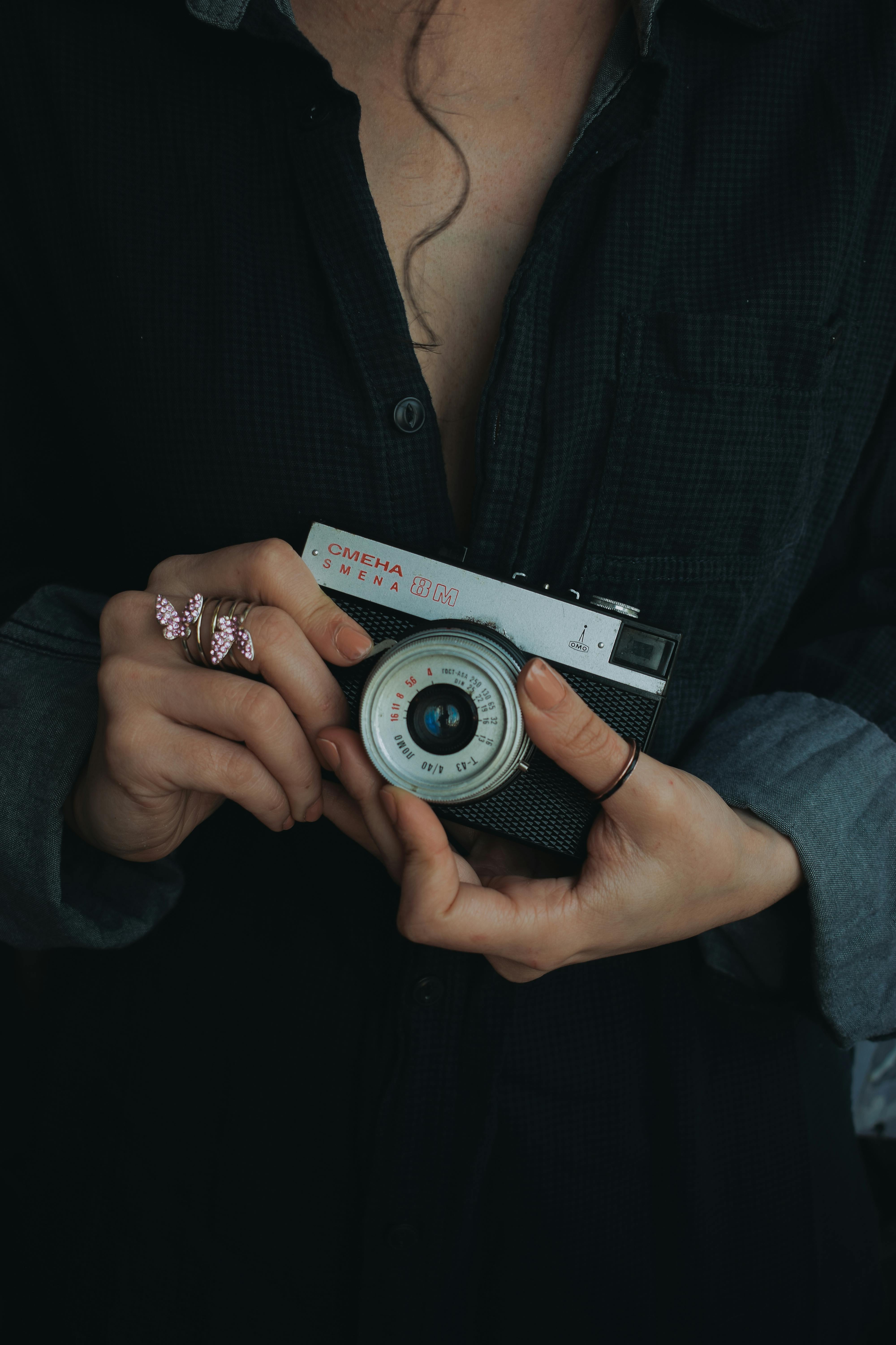 elegant vintage camera held by young woman