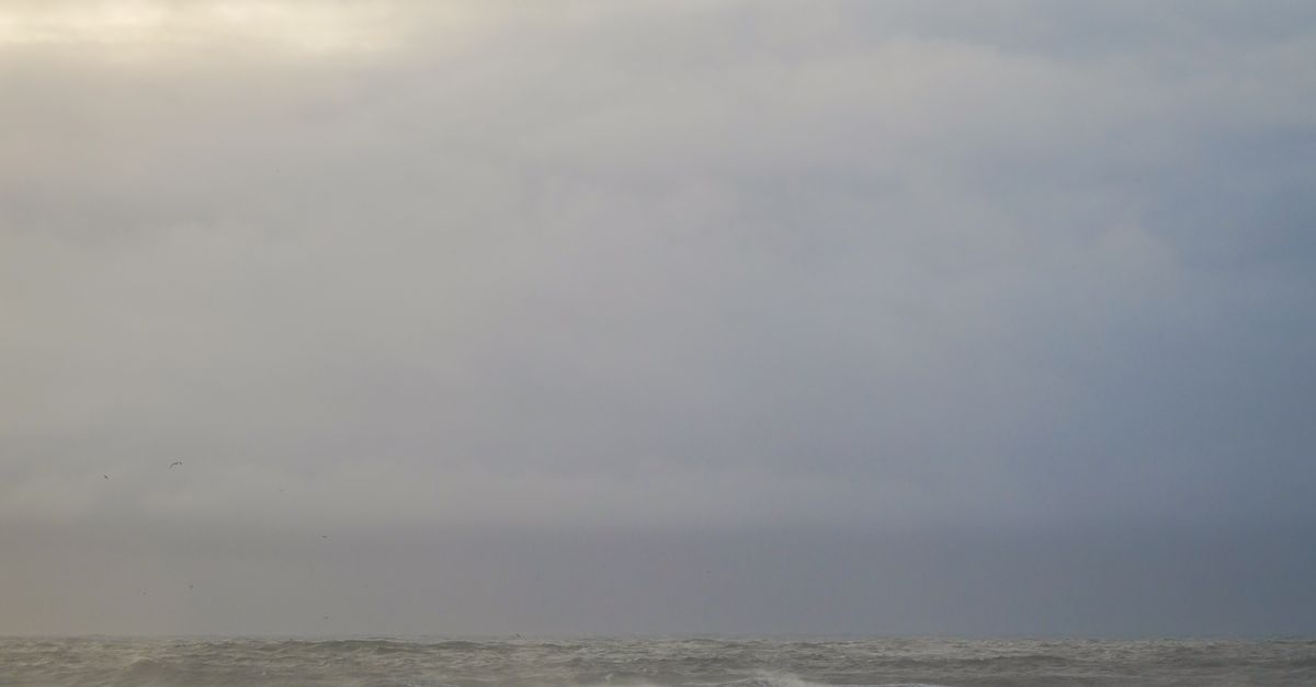 Photo by Swapnil Sharma Powerful ocean waves crash under a moody, stormy sky, capturing nature's raw beauty and force.