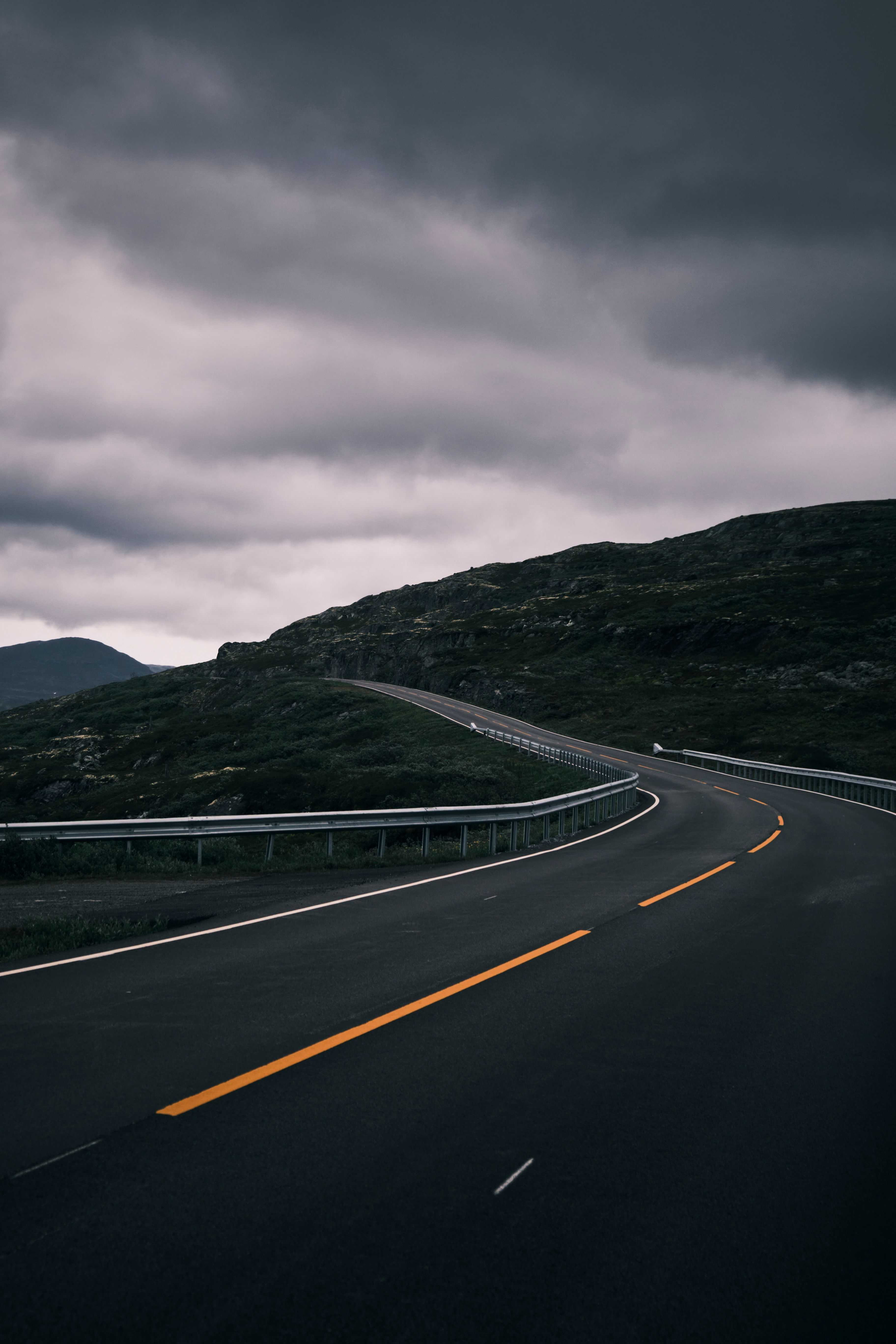 Dramatic Road Curves Through Rugged Landscape · Free Stock Photo