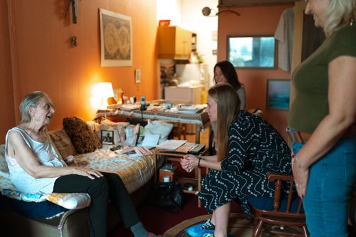Free A heartwarming moment between family members in a cozy living room setting, showcasing intergenerational bonding. Stock Photo