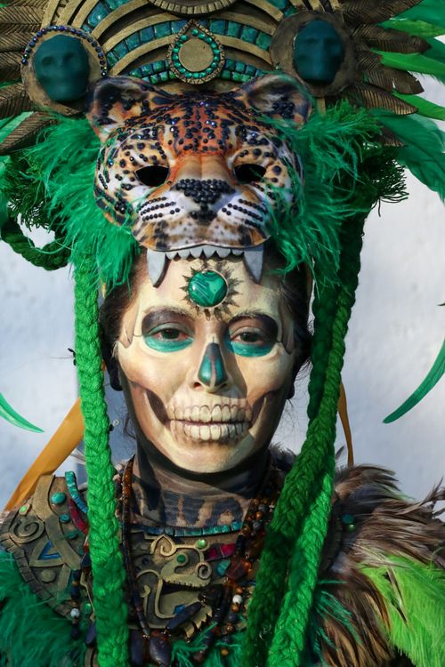 Free Intricate Mayan-inspired costume featuring a jaguar headdress and skull face paint, vibrant and artistic. Stock Photo