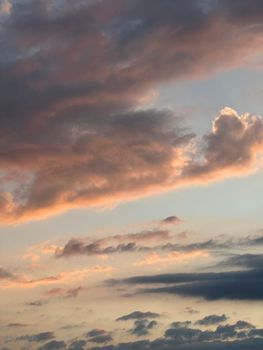 Dramatic sky with vibrant sunset hues and fluffy clouds, creating a serene atmosphere.