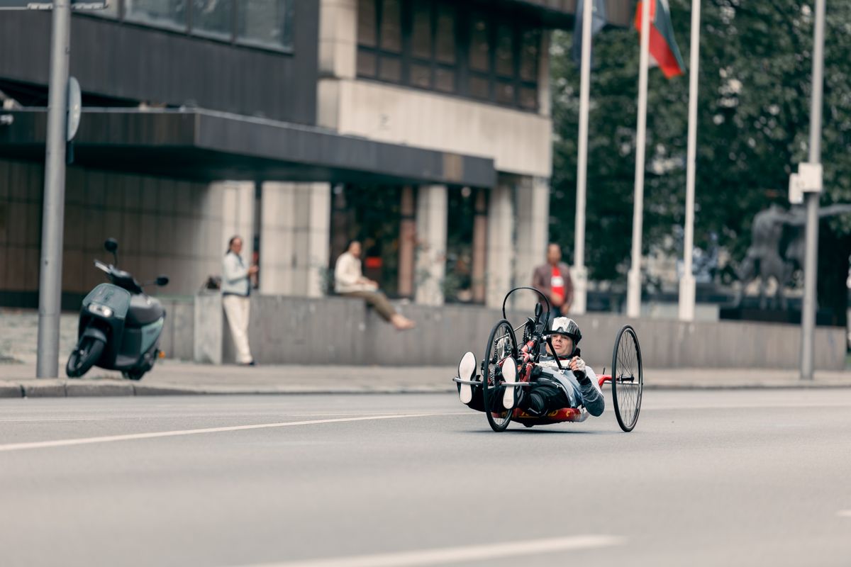 Rider using an adaptive handcycle on a modern city street