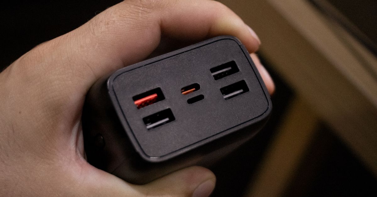 Multi USB power adapter held in hand
