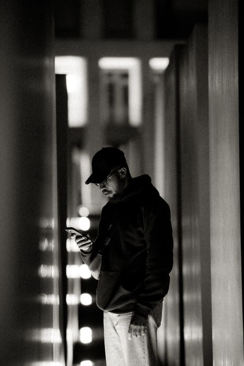 Free A modern black and white portrait of a man in Berlin's Holocaust Memorial at night. Stock Photo